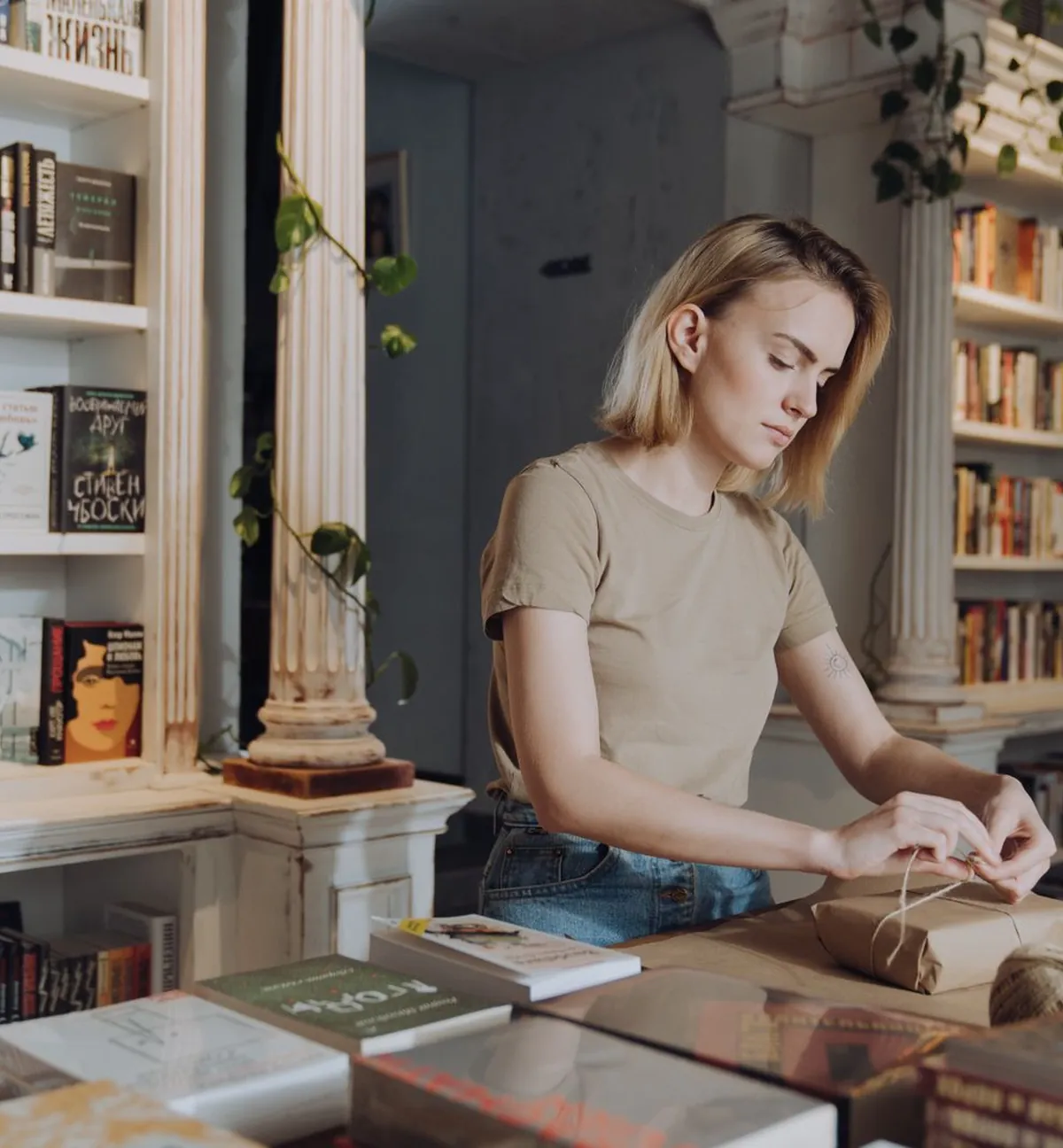 A bookseller arranging a table in an independent bookshop
